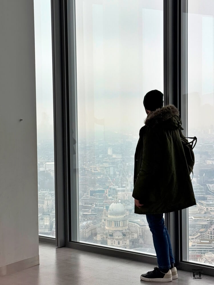 Está Nico de pie delante de un ventanal con vistas a Saint Paul 